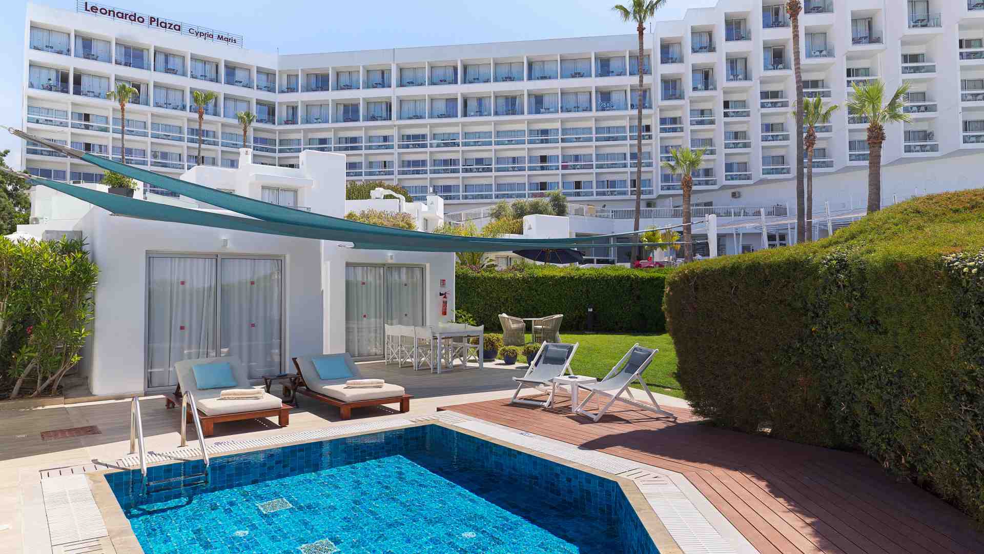 Beautiful lady relaxes by the pool of the Garden Suite