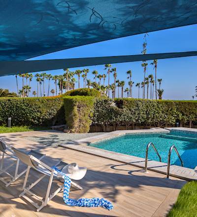 Beautiful lady relaxes by the pool of the Garden Suite